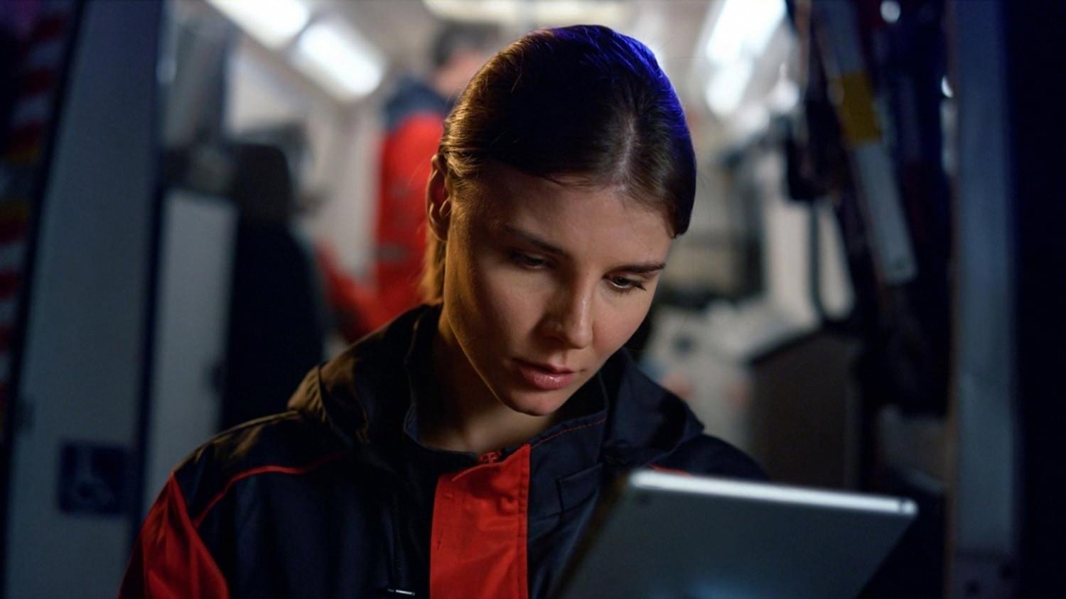 Car rental support agent reviewing a booking on a tablet, representing 24/7 customer service